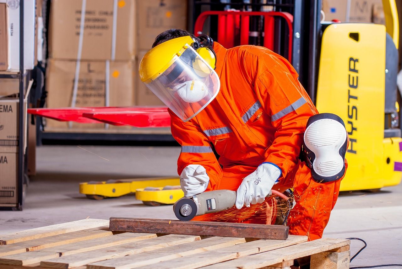 sleep safety worker with grinder in industrial place